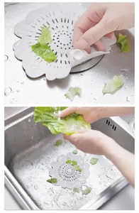 Close-up of white flower-shaped silicone sink strainer catching vegetable scraps in a kitchen sink.