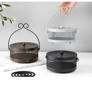 Detailed view of three decorative iron mosquito incense burners with floral carved lids