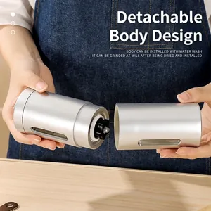 Portable silver manual coffee grinder with a detachable body design for easy cleaning.