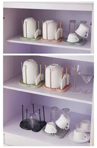 Multi-color kitchen bowl and cup drying racks organized in a white cabinet shelf