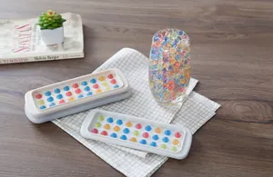 Close-up of spherical silicone molds with colorful resin balls on a wooden table