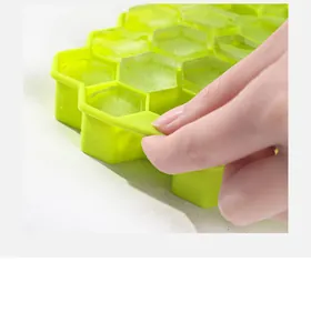Macro detail of a flexible green silicone honeycomb ice cube tray showing easy ice release