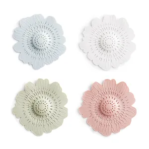 Flower-shaped silicone sink drain covers in four pastel colors for hair filtering