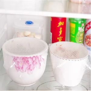 Detailed view of reusable silicone food wraps sealing ceramic bowls in a fridge