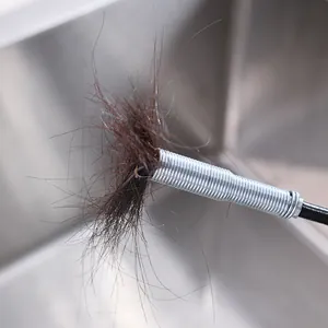 High-quality flexible metal drain clog remover tool grabbing hair from kitchen sink drain
