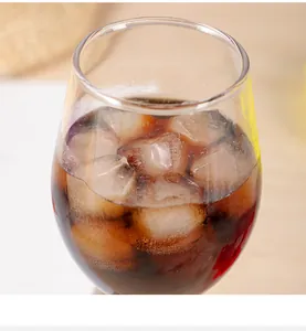 Macro detail of refreshing hexagonal honeycomb ice cubes in a cold coffee glass.