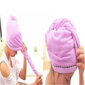 Detalle que muestra cómo retorcer y fijar el gorro de microfibra rosa para secar el pelo
