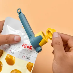 Durable blue and yellow plastic food sealing clip with discharge spout for kitchen storage.