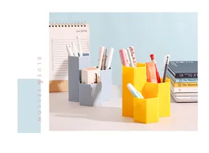 Close-up detail of modern hexagonal 3-slot pen holders for organized desk stationery storage