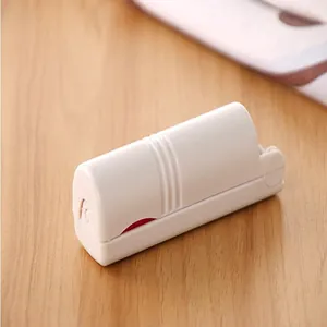 Close-up of a compact white foldable and washable lint roller for portable garment care
