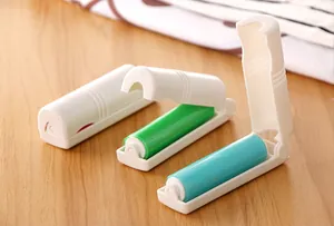 Detailed view of three mini foldable washable lint rollers in vibrant green and blue.