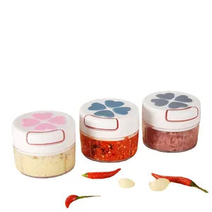 Three mini manual garlic choppers with heart lids on a white background