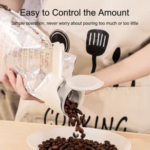 White plastic food bag sealing clip with spout pouring coffee beans into a bowl