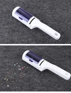 White manual lint roller for clothes and pet hair removal on grey felt background