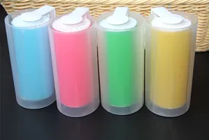 Set of four colorful washable lint rollers in blue, pink, green, and yellow with covers.
