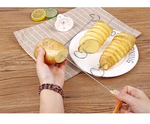Detailed view of hand-cranked manual spiral potato slicer tool kit in use