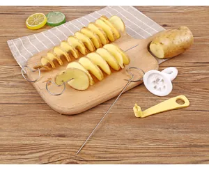 Close-up of manual tornado potato slicer set and spiral potato skewers on board.