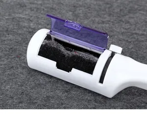 Detail view of pet hair remover brush with open compartment showing collected lint