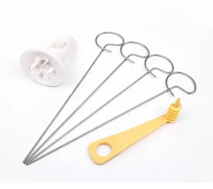 Detailed view of manual spiral potato slicer set with steel skewers and slicer tools