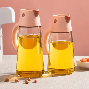 Two elegant glass oil and vinegar dispensers with automatic pink lids and handles for kitchen