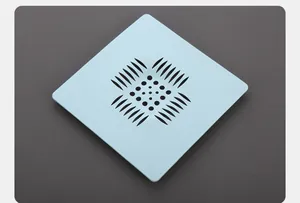 Close-up of square light blue silicone sink drain strainer with hair filter holes
