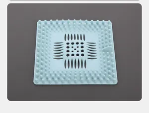 Close-up detail showing the texture and drainage holes of a blue silicone hair catcher.