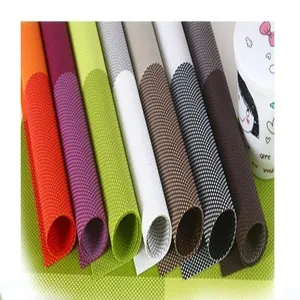 Detailed view of colorful PVC woven placemats with heat-resistant grid texture