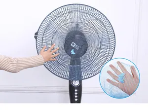 Close-up of blue mesh fan safety cover with butterfly detail protecting child's hand
