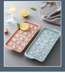 Detail view of two colorful plastic ice ball molds with 18 compartments for ice balls.