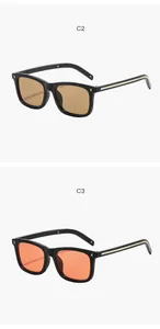 Détail de lunettes de soleil carrées rétro avec verres de couleur marron et orange