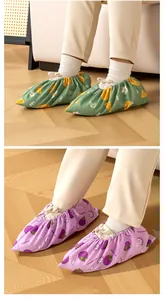Close-up of children's fabric shoe covers with green orange and purple mangosteen prints