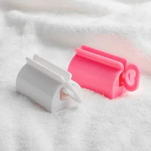 Presse-tube de dentifrice manuel à rouleau en blanc et rose pour la maison