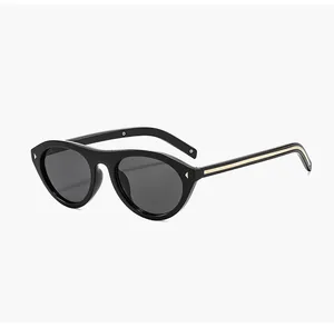 Close-up detail of retro black cat eye sunglasses with gold stripe and rivet accents.
