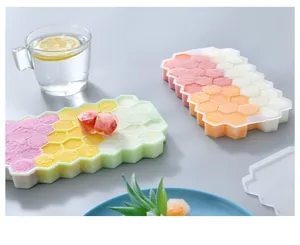 Detail view of honeycomb silicone ice cube mold tray with lid in a modern kitchen setting