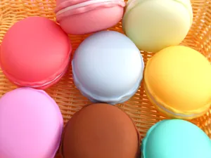 Detailed view of colorful macaron-shaped plastic jewelry storage boxes in a basket