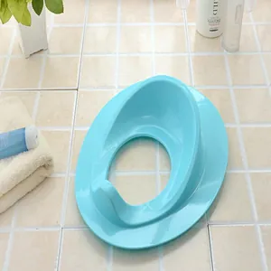 Detailed view of a blue baby potty seat trainer ring placed on a clean tiled bathroom floor