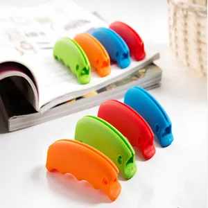 Close-up of candy-colored silicone bag carriers in orange, green, and red colors