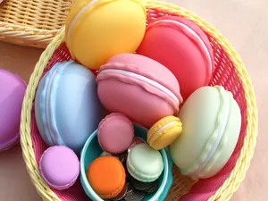 Close-up of colorful macaron-shaped storage boxes for jewelry organized in a basket