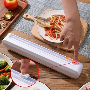 White plastic wrap dispenser with sliding cutter for kitchen organization