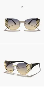 Detailed view of rimless butterfly sunglasses with gradient lenses and gold wing-side shields.