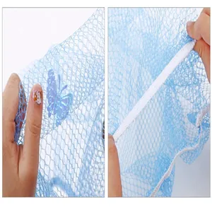 Close-up of blue mesh safety fan cover showing fine netting texture and white elastic border