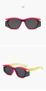 Detail view of pink and yellow children's sports sunglasses with hollowed-out curved frames.
