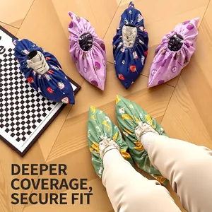 Cartoon fruit pattern children's cloth shoe covers displayed on wooden floor, washable fabric