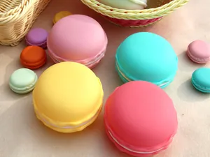 Close-up of colorful macaron-shaped portable jewelry storage boxes in a cozy setting.