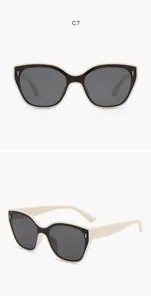 Close-up views of trendy kids two-tone cat-eye sunglasses with cream and black frames
