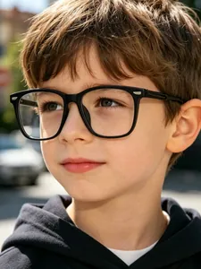 Detailed view of child wearing square black frame blue light blocking glasses outdoors.