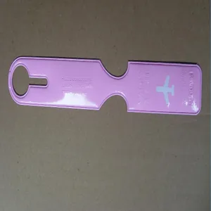Detail shot of a minimalist pink long strip luggage tag featuring a white airplane icon
