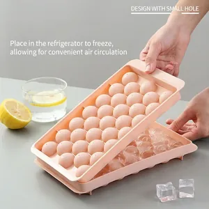 Pink sphere ice cube tray with small hole lid design for efficient freezing in fridge