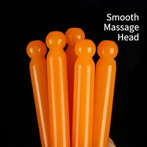 Set of orange meridian massage sticks with smooth rounded heads for facial scraping