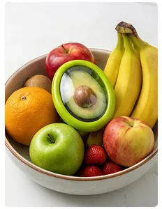 Avocado saver storage container displayed in a fruit bowl with apples and bananas.